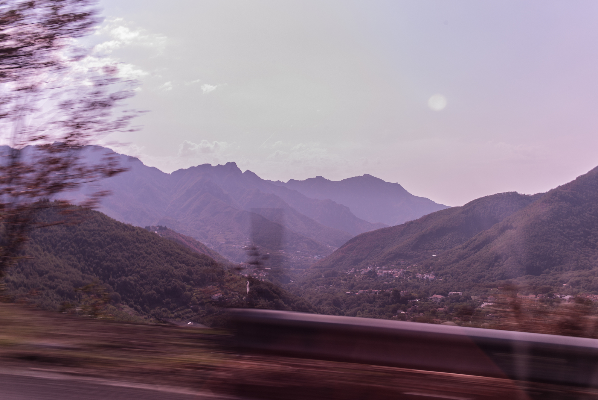 Impressionistic motion blur of lush green hills and terraced valleys along Italy's Amalfi Coast.