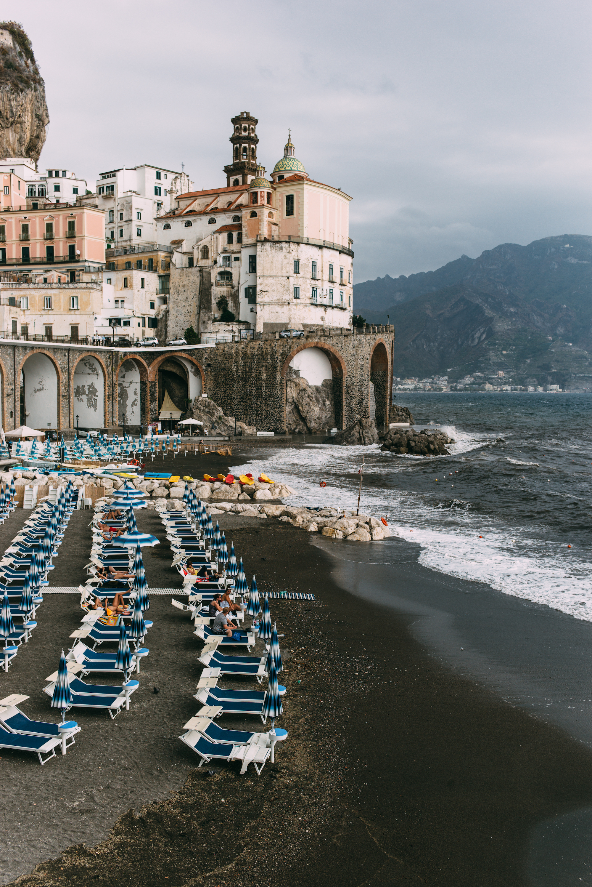 Limestone cliffs plunging steeply into the misty blue waters of the Gulf of Salerno on the Amalfi Coast.