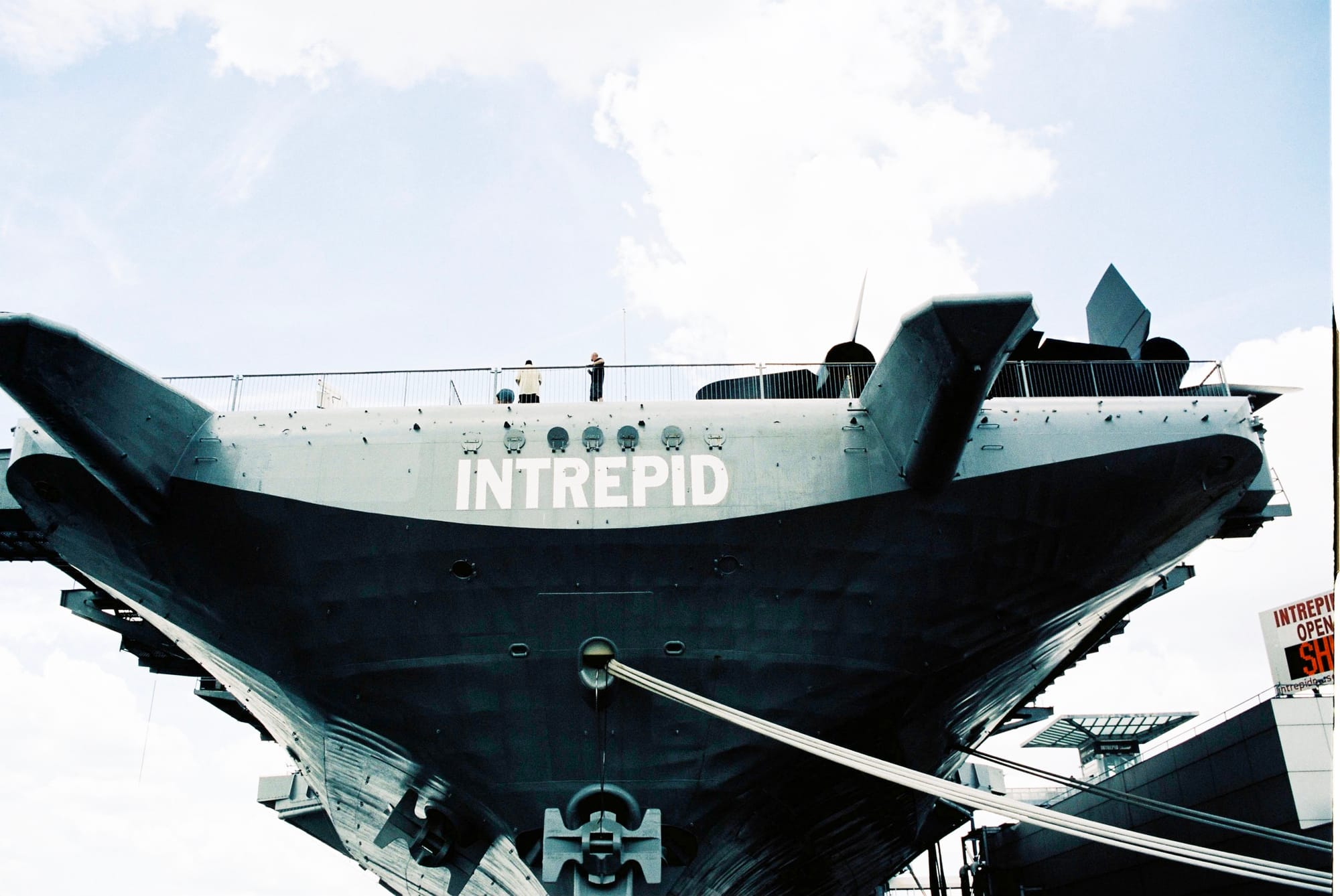 Symmetrical view of the massive steel bow and anchors of the USS Intrepid docked in the Hudson River.