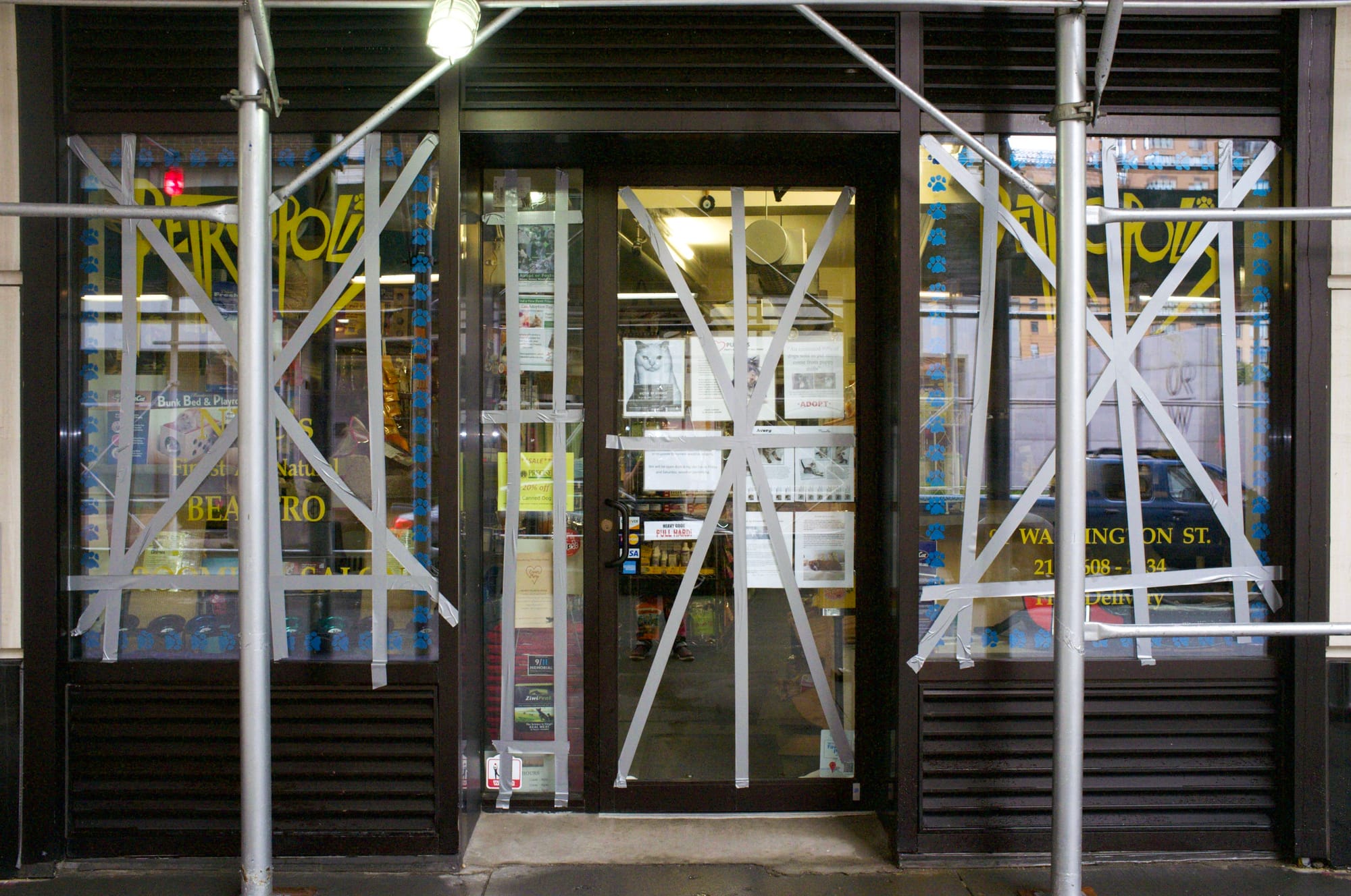 Empty sidewalks and darkened commercial storefronts in evacuated Zone A of Lower Manhattan during Hurricane Irene.