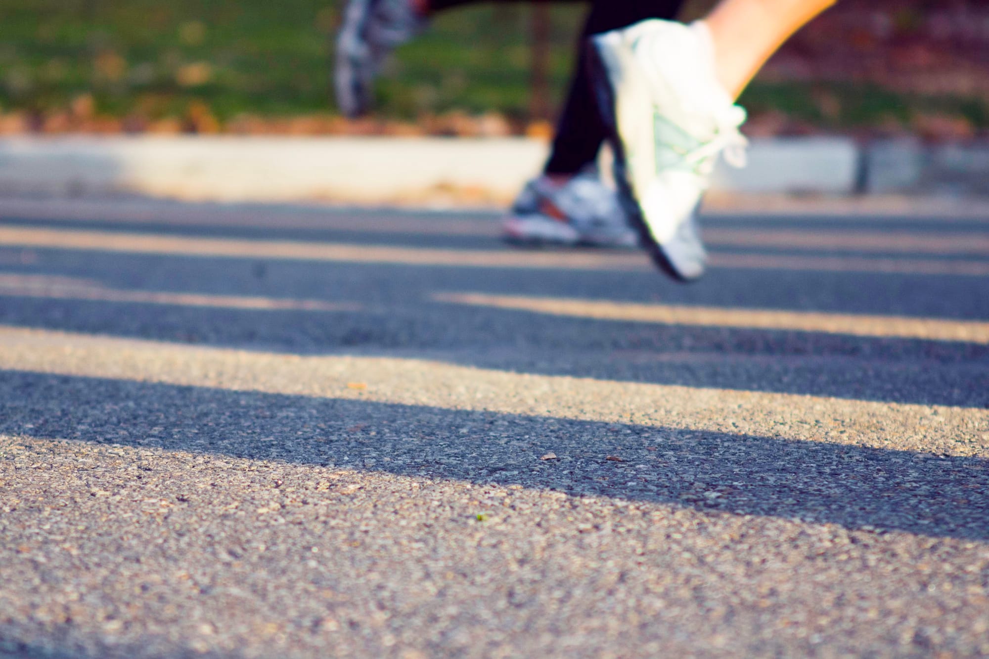 Close-up action shot of running sneakers in mid-stride during the New York City Half Marathon.