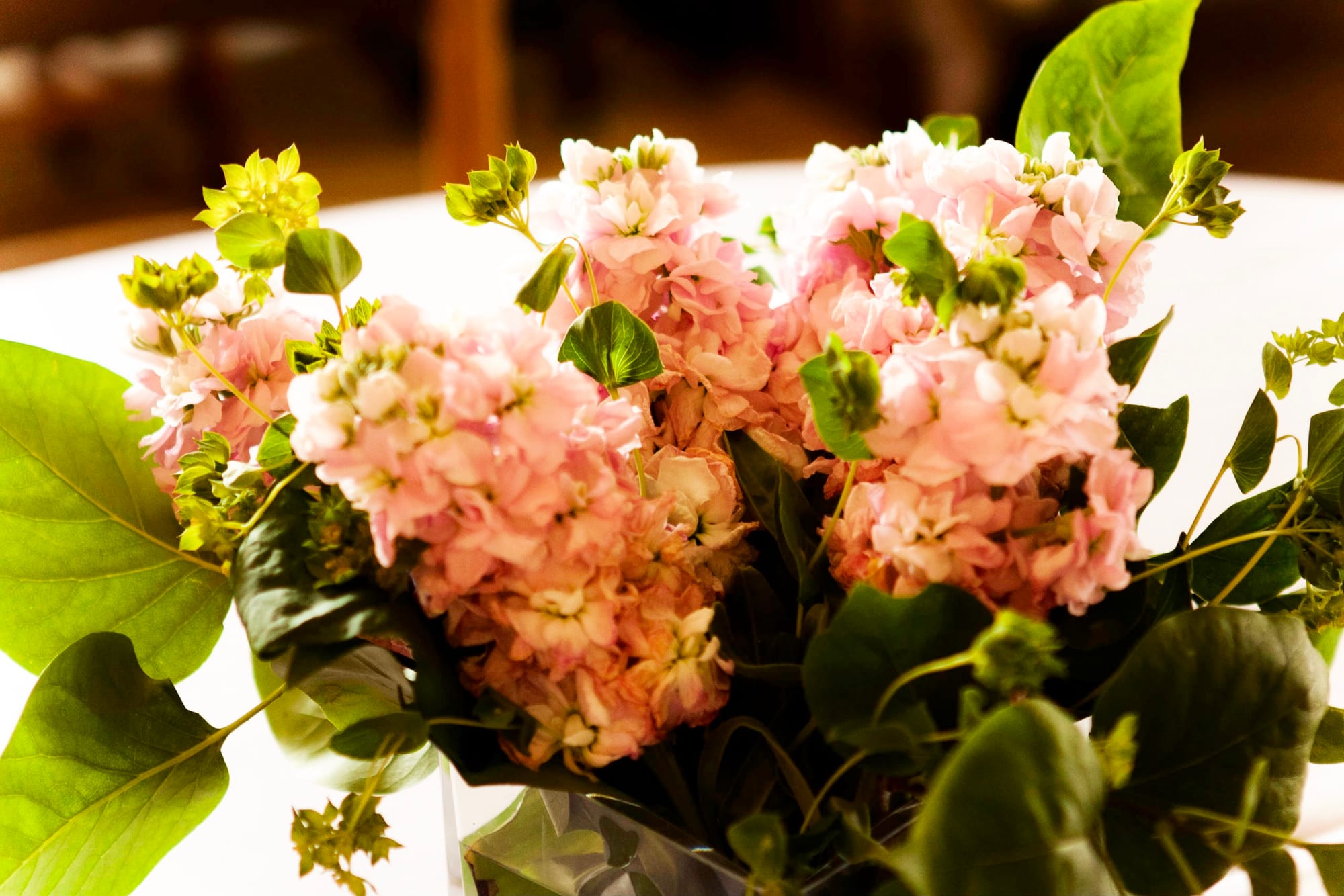Elegant floral arrangements and centerpieces prepared for an outdoor bridal shower in Michigan.