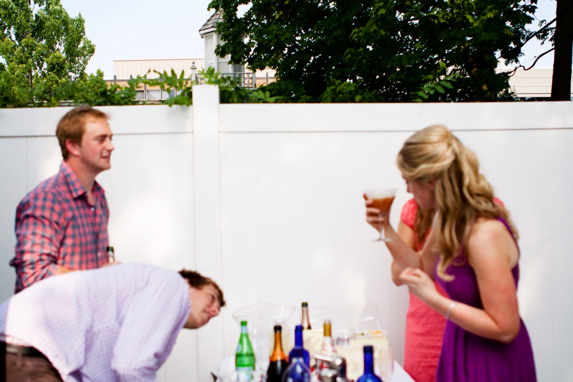 Attendees laughing and celebrating during an outdoor summer bridal shower gathering in Michigan.