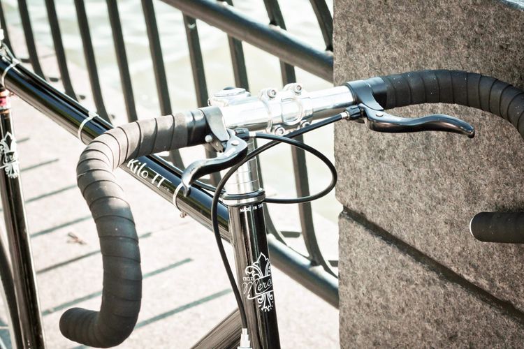Close-up detail of bicycle handlebars, frame geometry, and drivetrain on a new commuter bike in New York City.