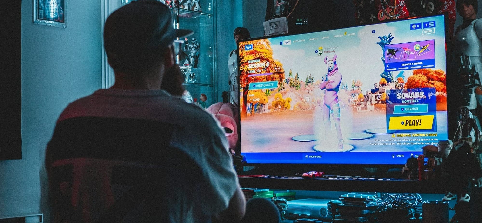 man in red shirt watching tv