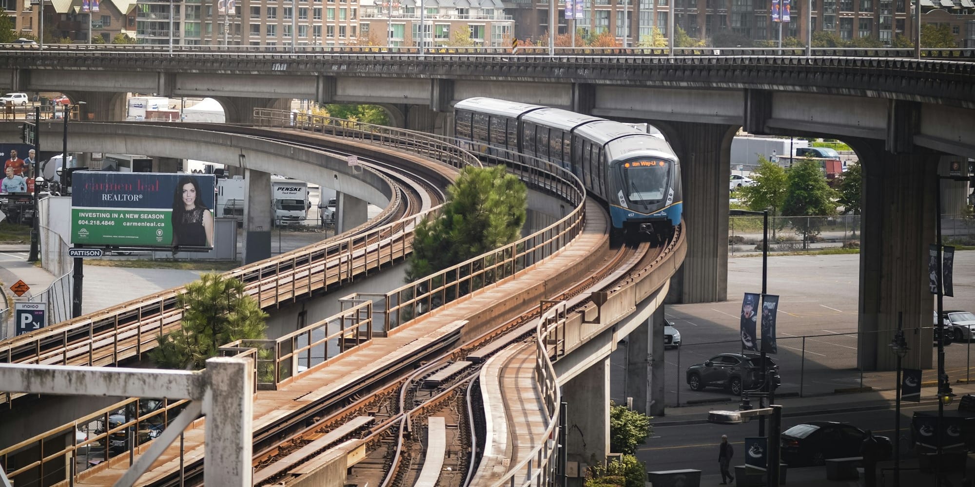 a train traveling down tracks under a bridge
