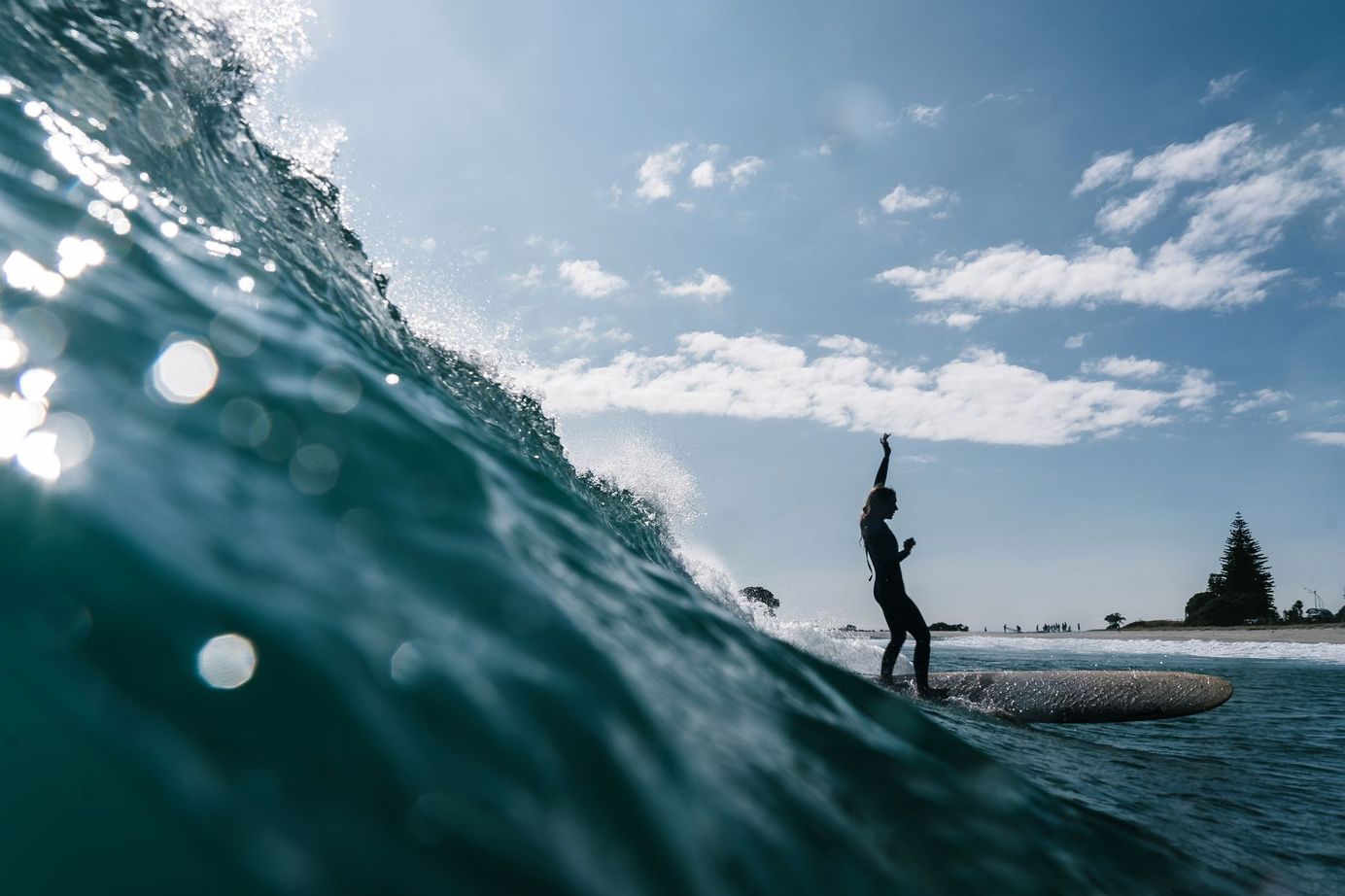 female surfer on a longboard in New Zealand