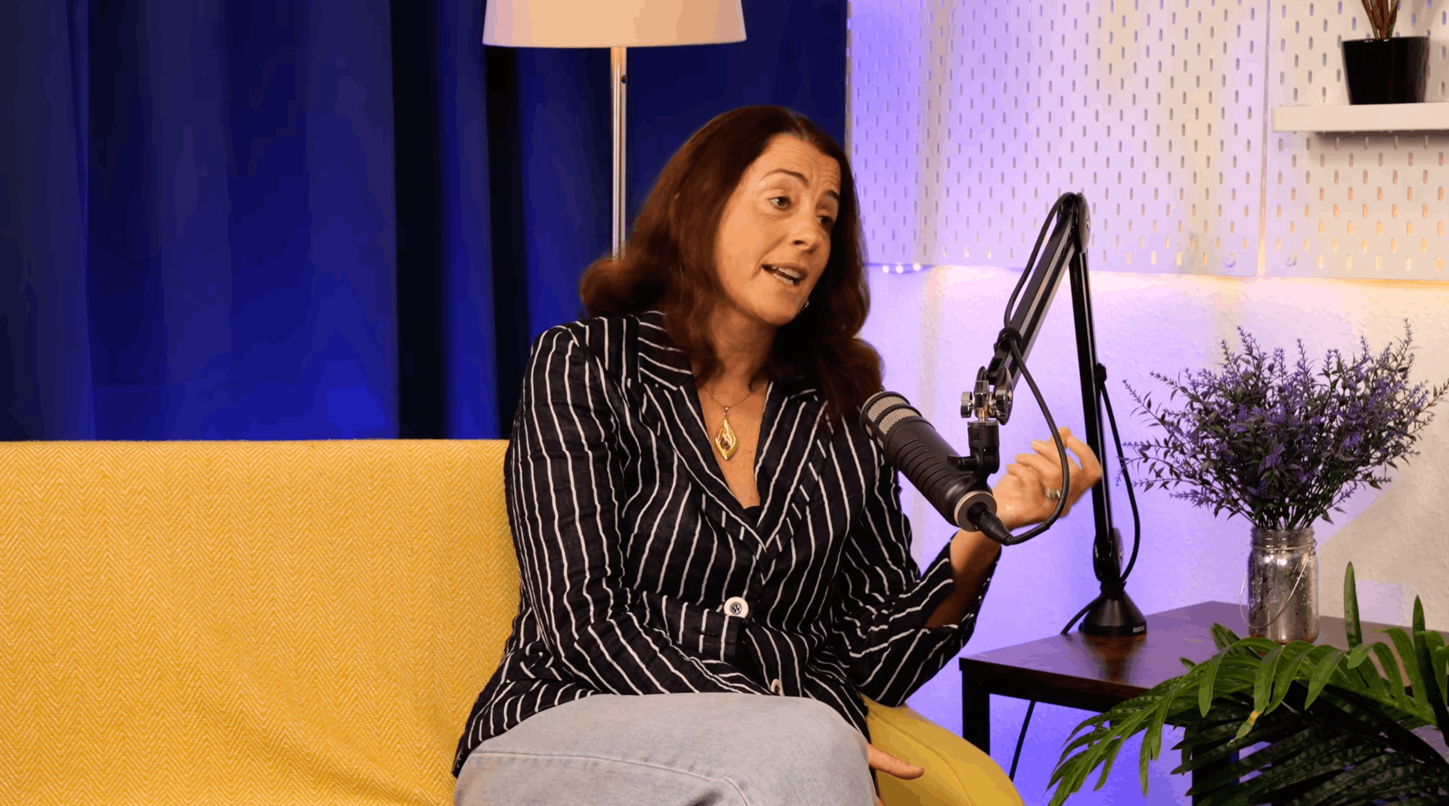 Jenny Tschiesche speaking at the microphone during her BEYOND interview, gesturing as she makes a point
