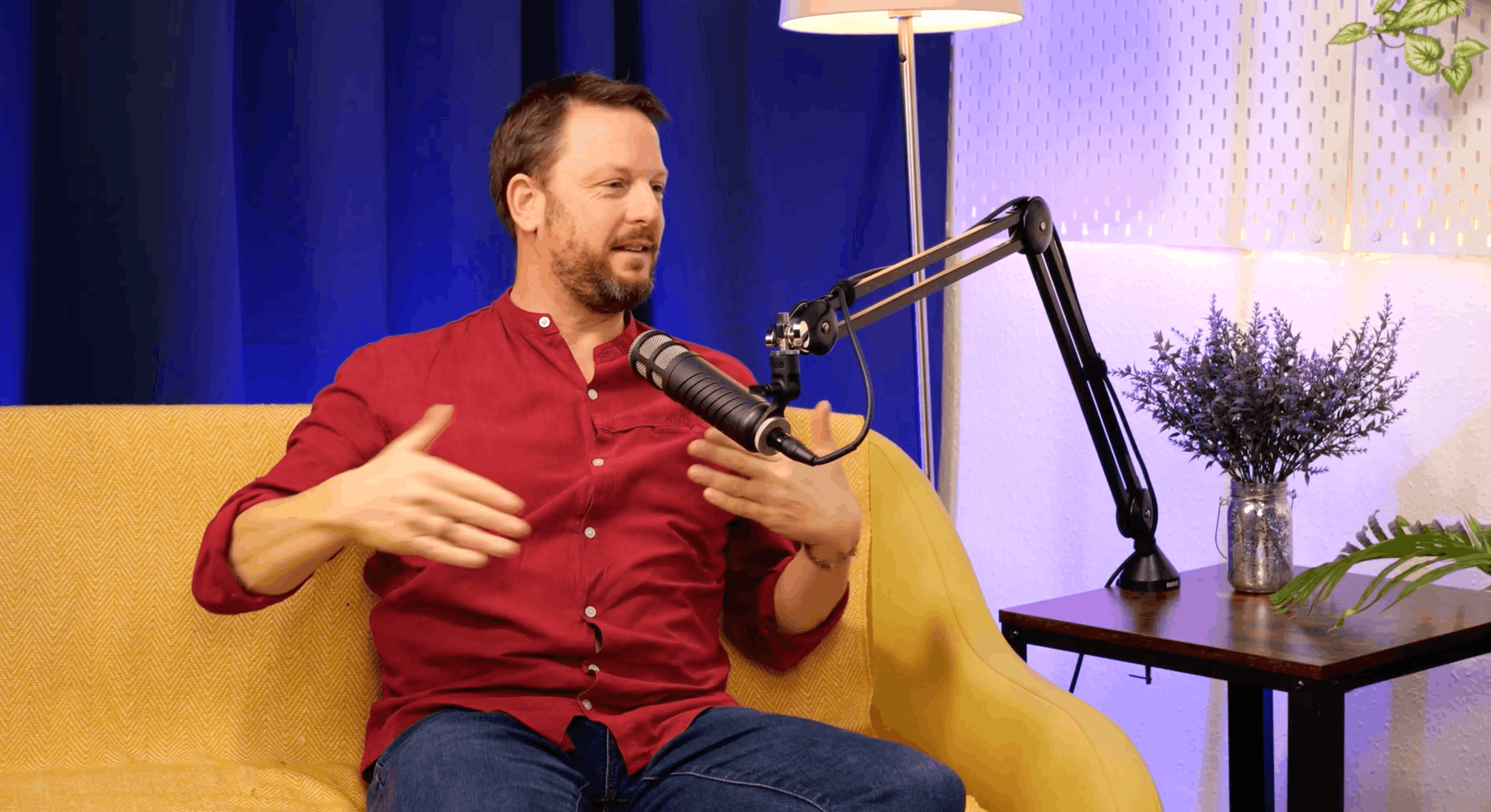 Matthew Matheson gesturing with both hands as he makes a point at the microphone during his BEYOND interview