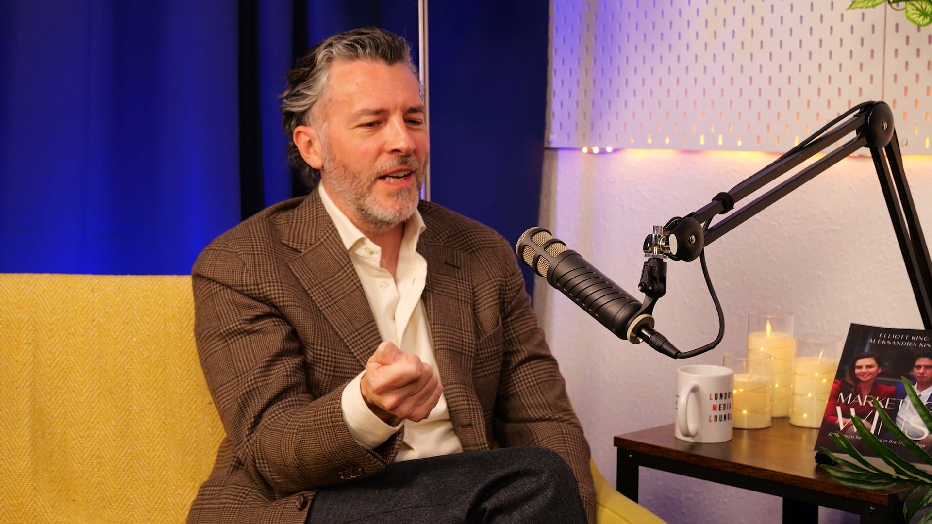 Anthony Flynn leaning forward to make a point during his BEYOND interview, podcast microphone beside him