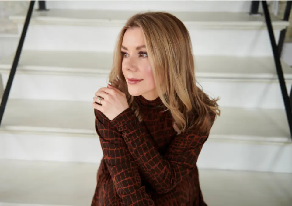 Jennifer Hanway, health and fitness expert, sitting down on some stairs.