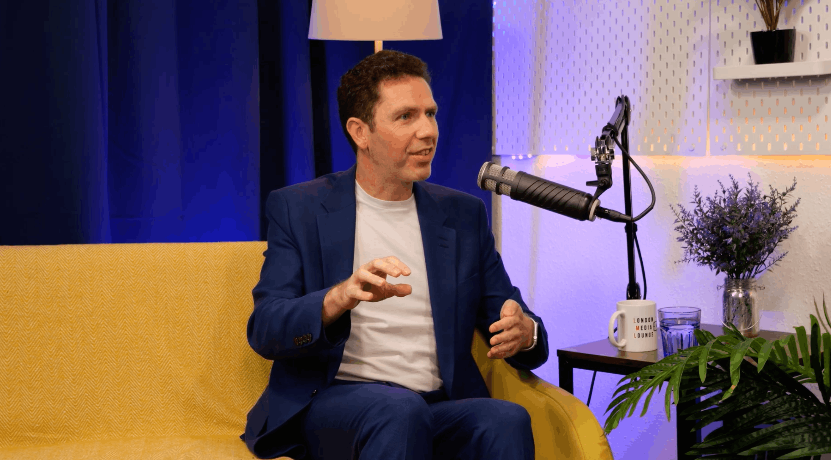 David Robson gesturing as he explains an idea at the microphone during his BEYOND interview