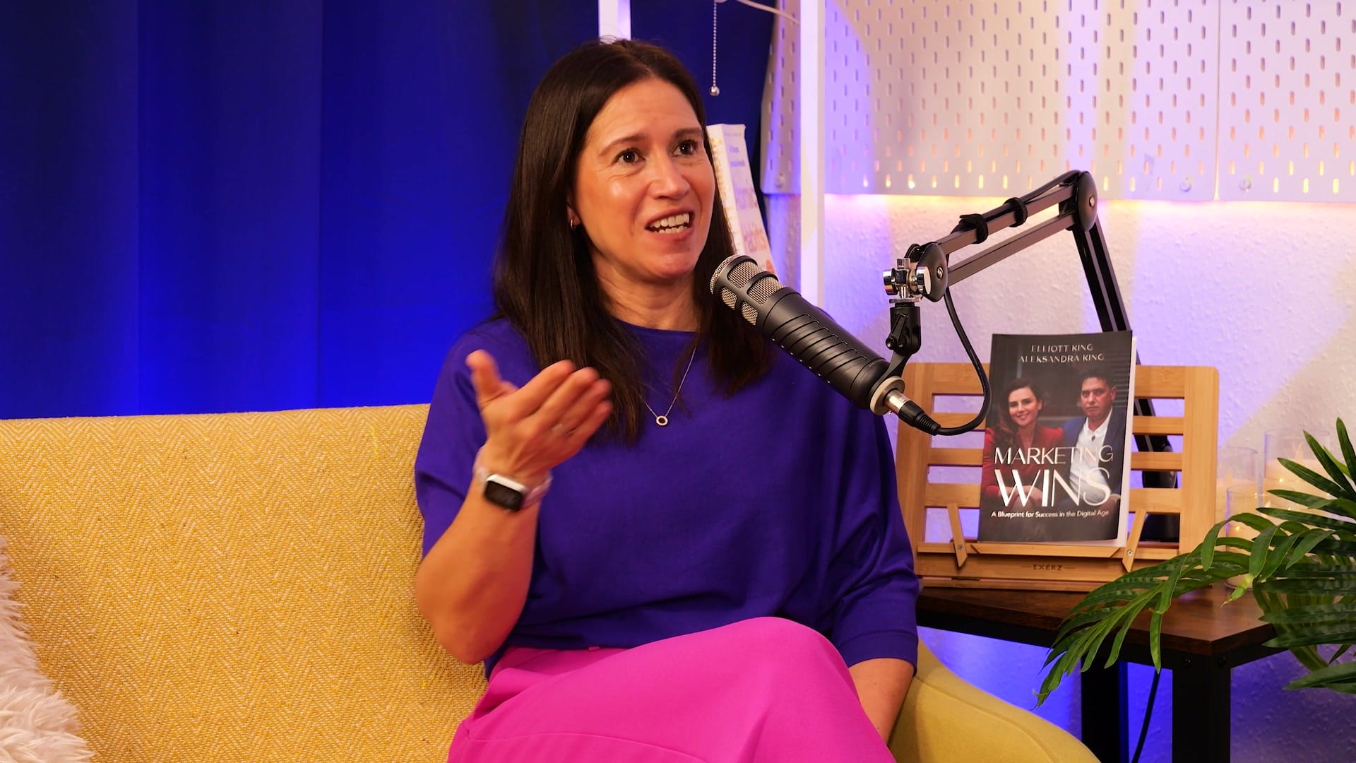 Anna Hemmings gesturing as she makes a point on The BEYOND Podcast, microphone in front of her