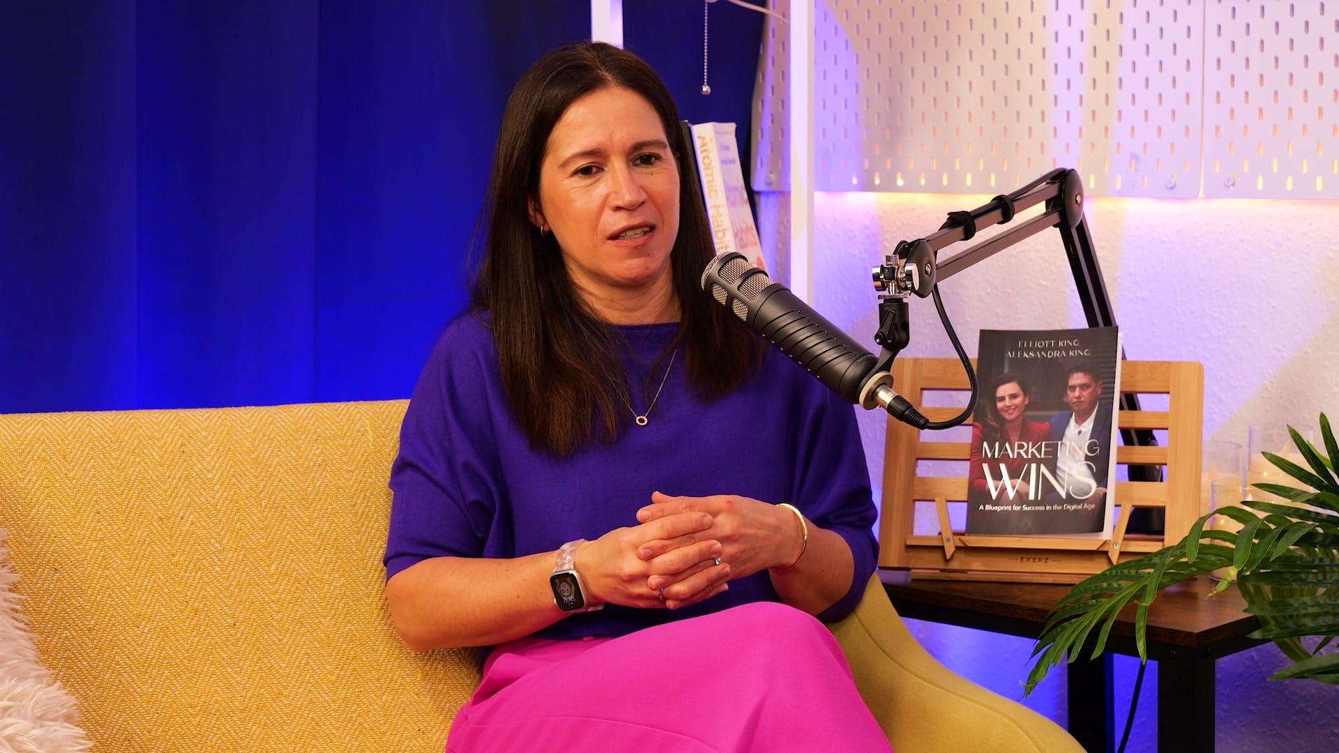 Anna Hemmings listening intently on The BEYOND Podcast set, hands clasped