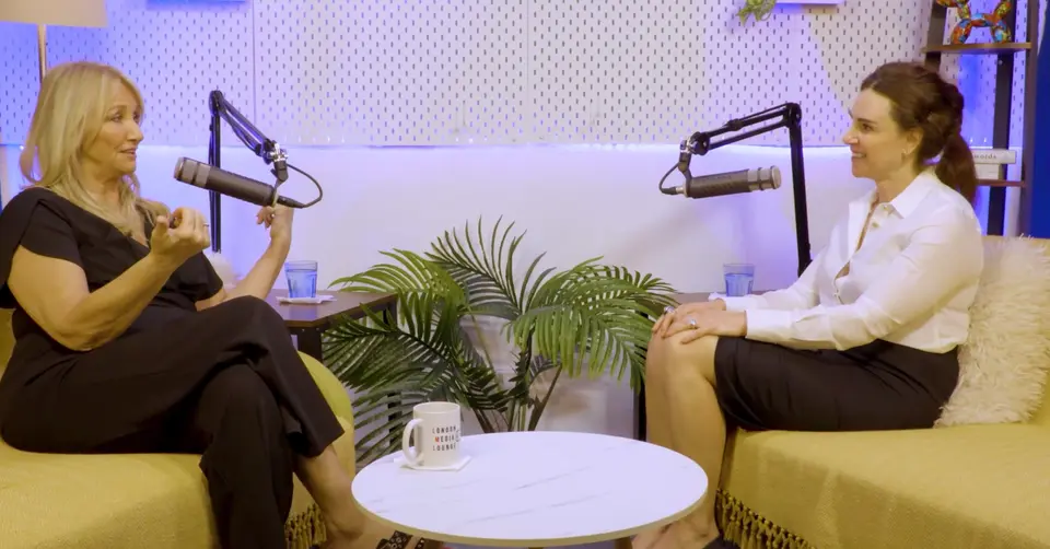 Deborah Mitchell and Aleksandra King in conversation across a coffee table in the studio