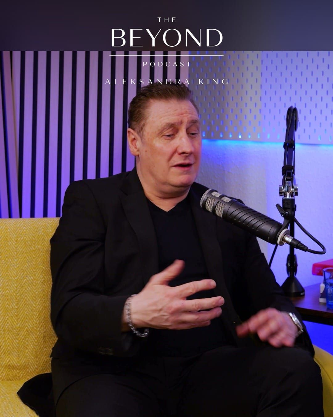 Grant Murrell gesturing as he talks at a studio microphone, under The BEYOND Podcast logo