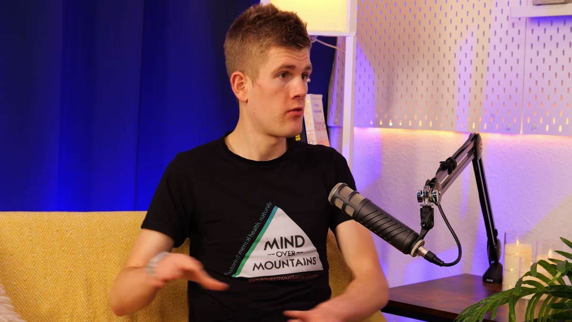 Alex Staniforth gesturing as he explains a point on The BEYOND Podcast set