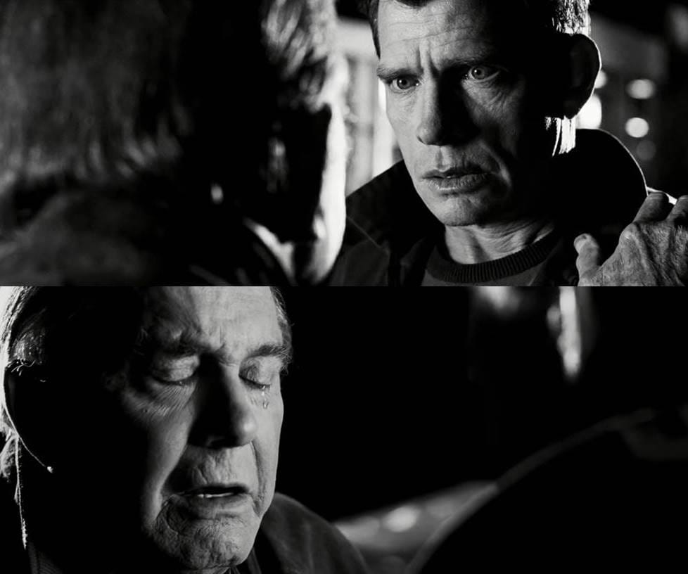 Two shots in black & white from Spider-Man 3. The flashback where Flint Marko kills Uncle Ben. Flint looks at Ben. Ben looks at Flint.