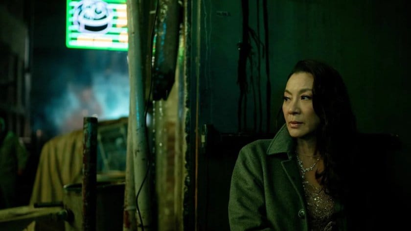 Everything Everywhere All At Once: Evelyn sits in an alley, dressed for a film premiere and hiding in the shadows.