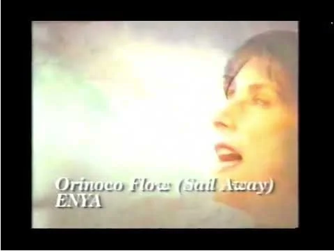 Screen cap of the Pure Moods CD commercial. A singing woman's face with words superimposed: Orinoco Flow (Sail Away) ENYA