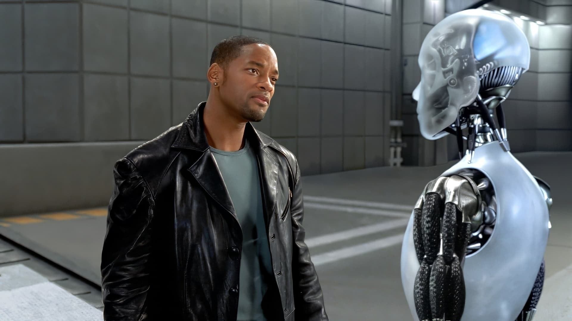 I, Robot - Will Smith tilts his head while looking at a creepy humanoid robot with a semi-transparent shell.