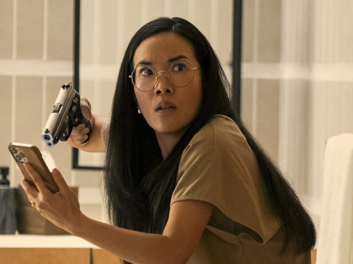 Ali Wong holds a gun to a phone in a scene from BEEF