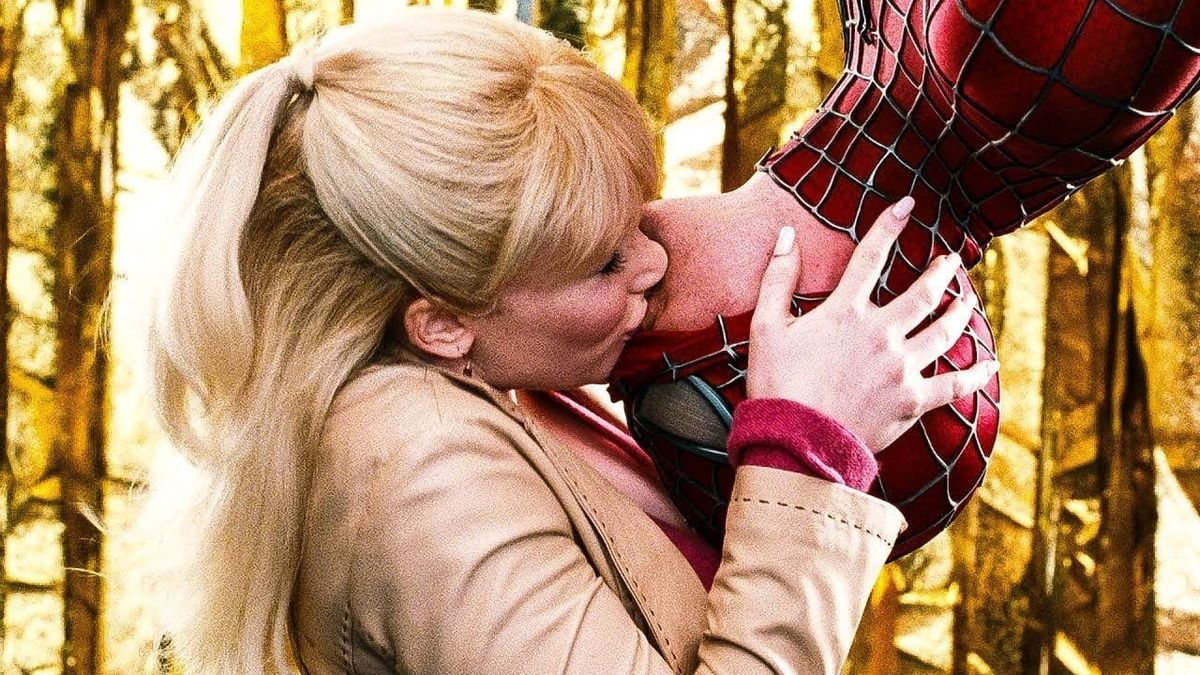 From Spider-Man 3, Peter Parker hangs upside down over a stage for a Spider-Man rally and lets Gwen Stacy kiss him after the crowd eggs them on.