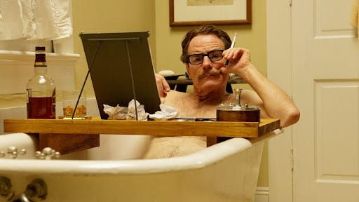 Dalton Trumbo (played by Bryan Cranston) writing in the bathtub.
