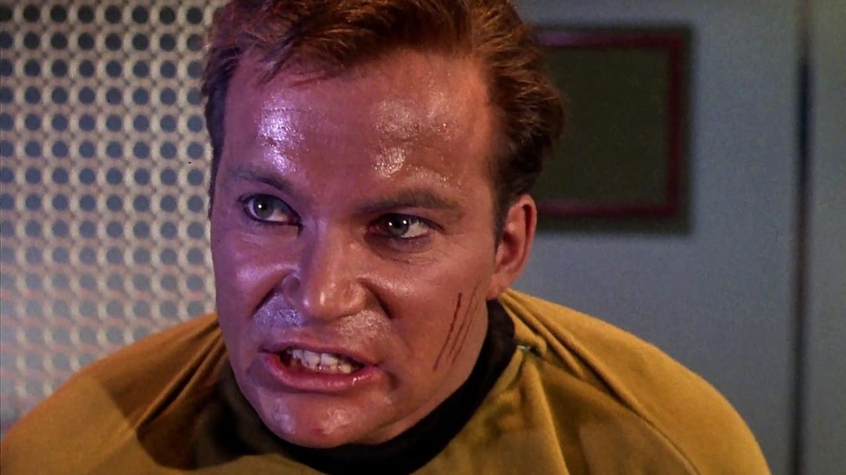 Star Trek: TOS - Captain James Kirk is sweaty and has scratches on his cheek. He grits his teeth in rage.