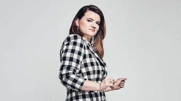 Leslye Headland stands in a black and whit checked blazer