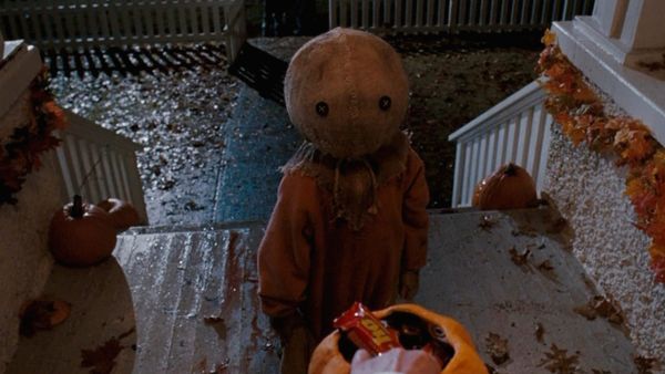 A small child with a burlap sack over its head goes trick-or-treating in a still from Trick 'r Treat