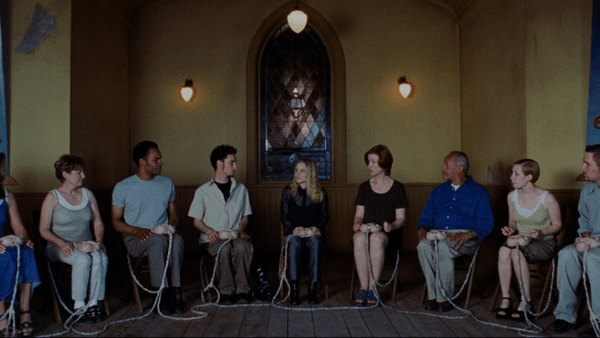 Existenz - A focus group prepares to beta test a video game with organic controllers in their laps connected to the control ports in their bodies.