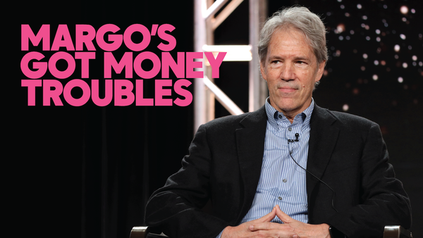 David E. Kelley, a white, grey haired man wearing a suit, sits onstage at an event for Margo's Got Money Troubles