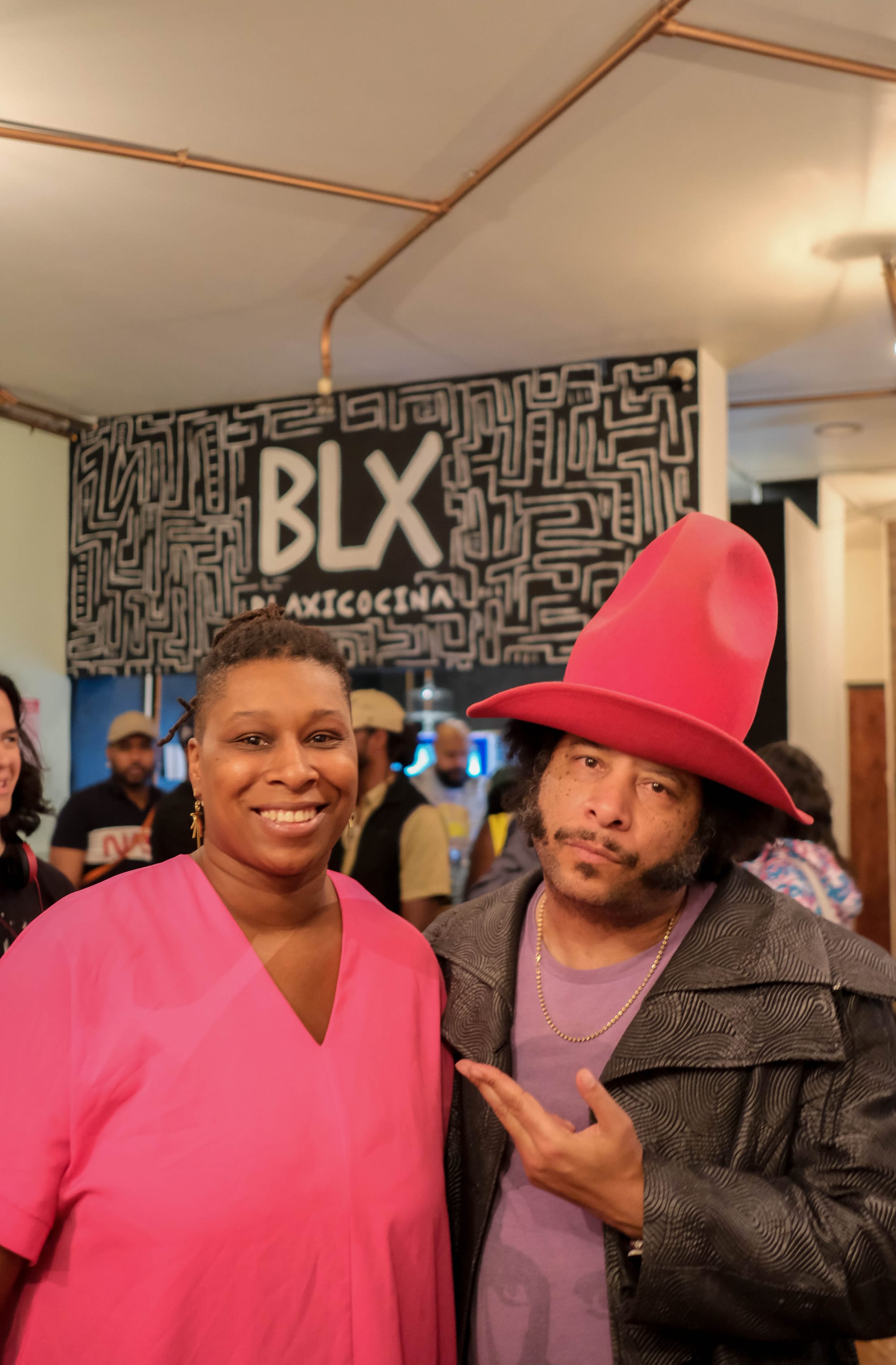 Tiara Darnell poses with the director. Her pink shirt matches his big, tall, pink cowboy hat.