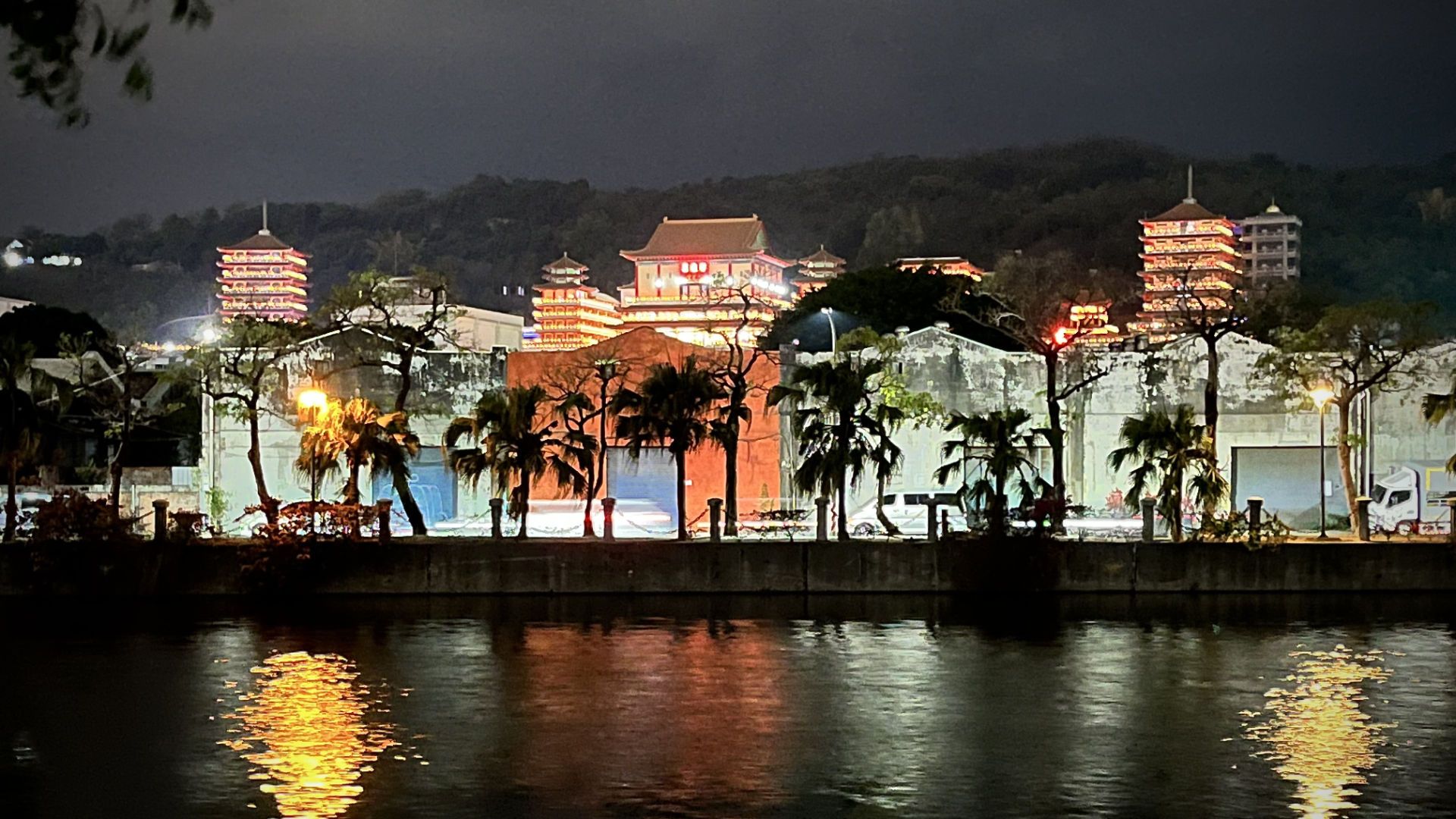 Grand red-and-gold buildings in the distance.