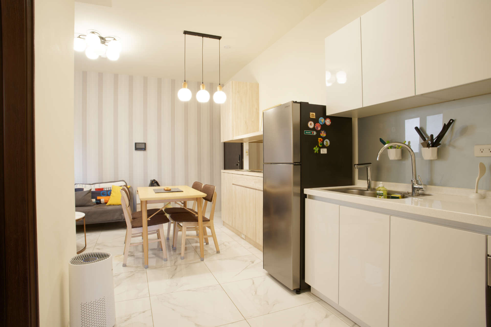 Wide-angle view of the kitchen and living area, including ceiling lights.