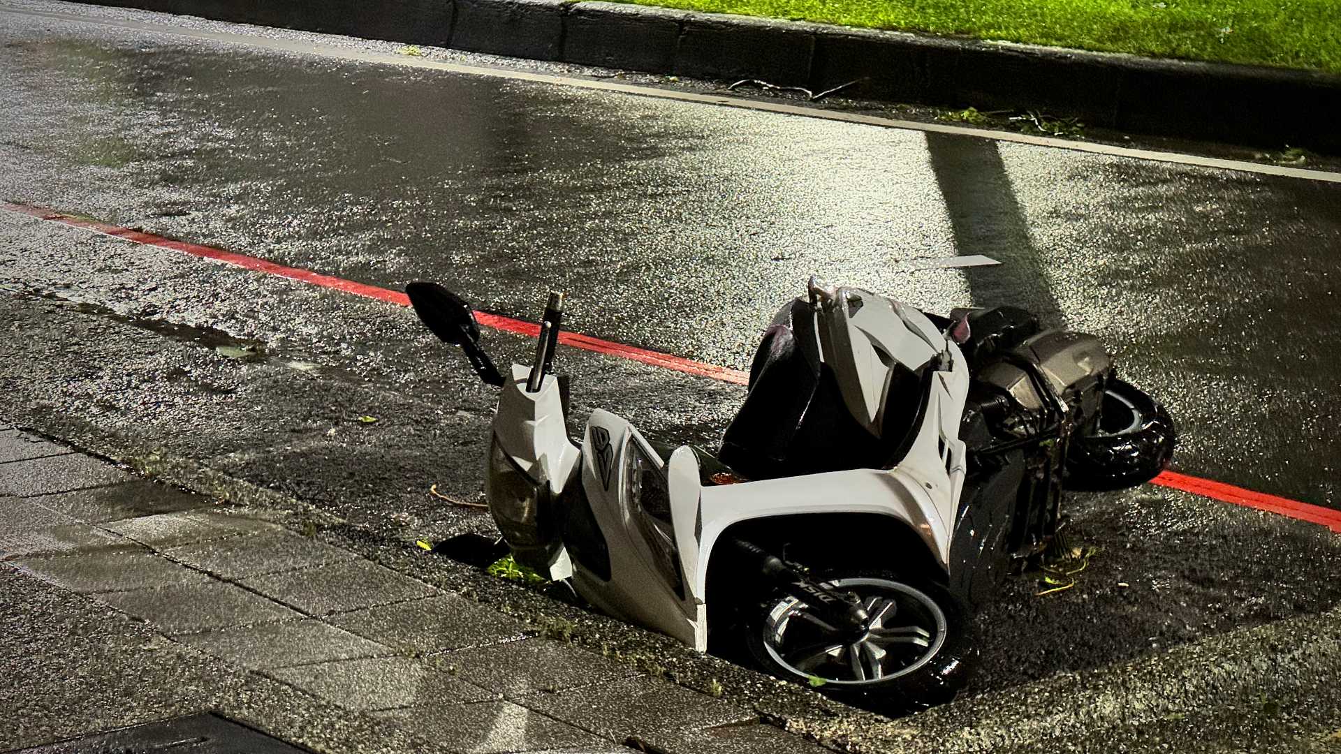 A topped motorbike on its side.
