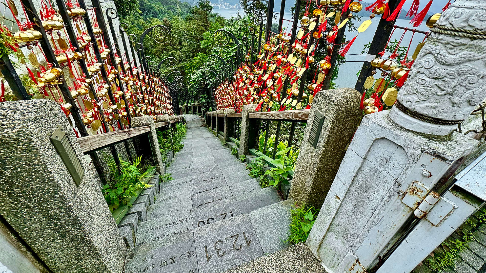 Stone steps leading uphill from Sun Moon Lake. Each step has a date engraved inside it.