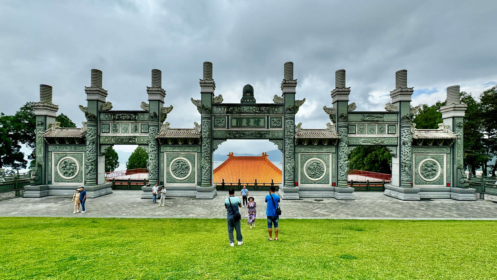 View from the top of Sun Moon Lake Wenwu Temple. Tourists are taking photos in the foreground.