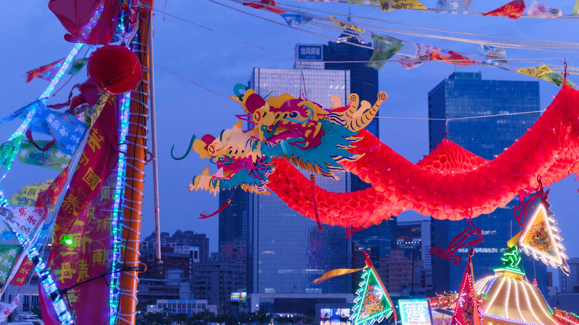 Close-up of the heads of two dragons, hanging above the forward deck of a Taiwanese fishing boat.