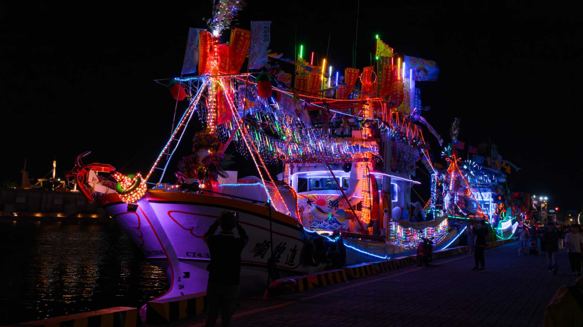 A densely-decorated Taiwanese fishing boat docked at the Pier-2 Art Center in Kaohsiung. It is covered in colorful hanging LED lights.