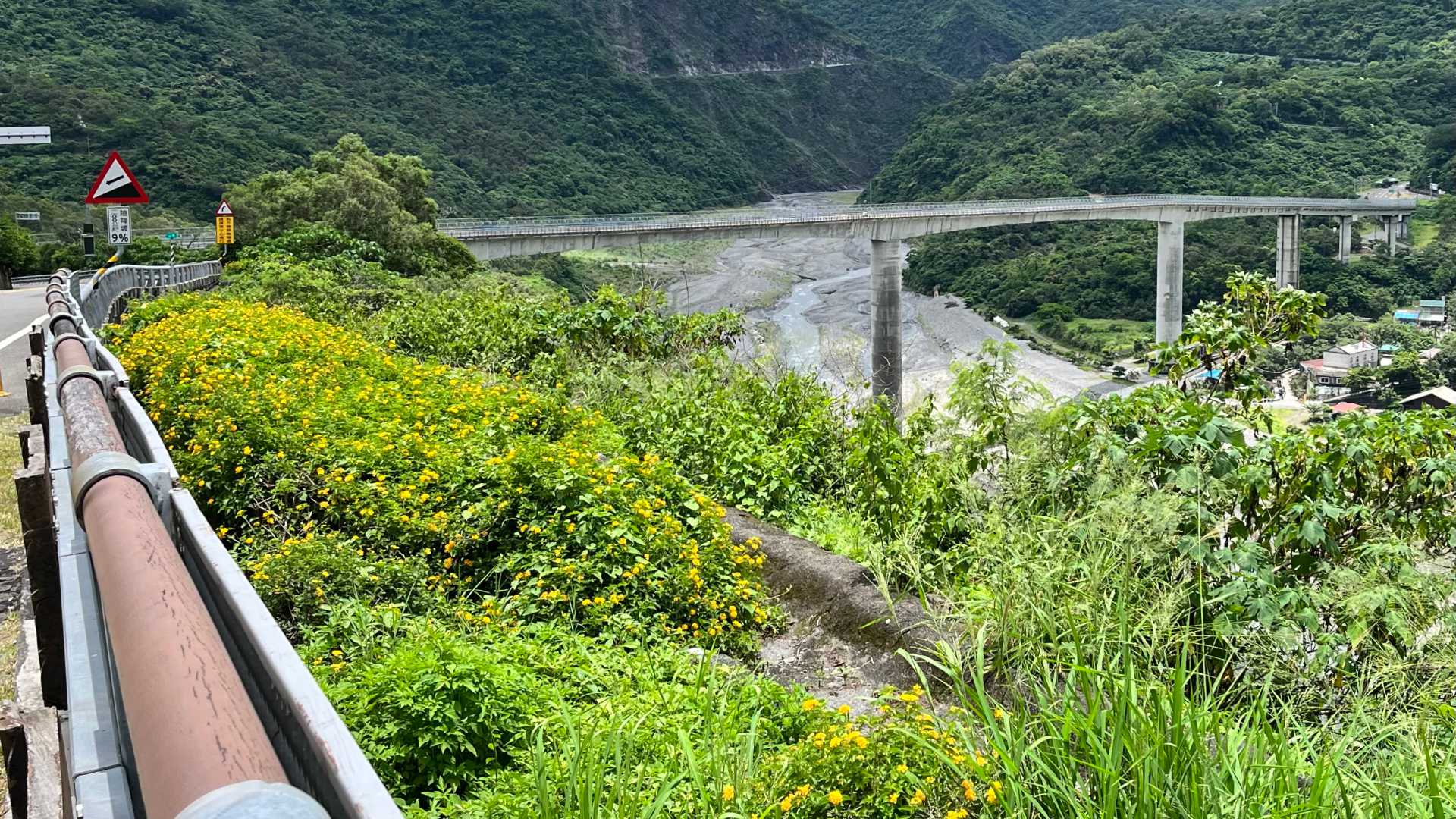 A large, modern concrete viaduct across a mountain river in Pingtung County.