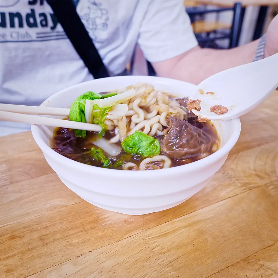 A vibrant-looking bowl of fresh beef noodle soup at Jiaxiang Beef Noodle Restaurant in Tainan City, Taiwan.