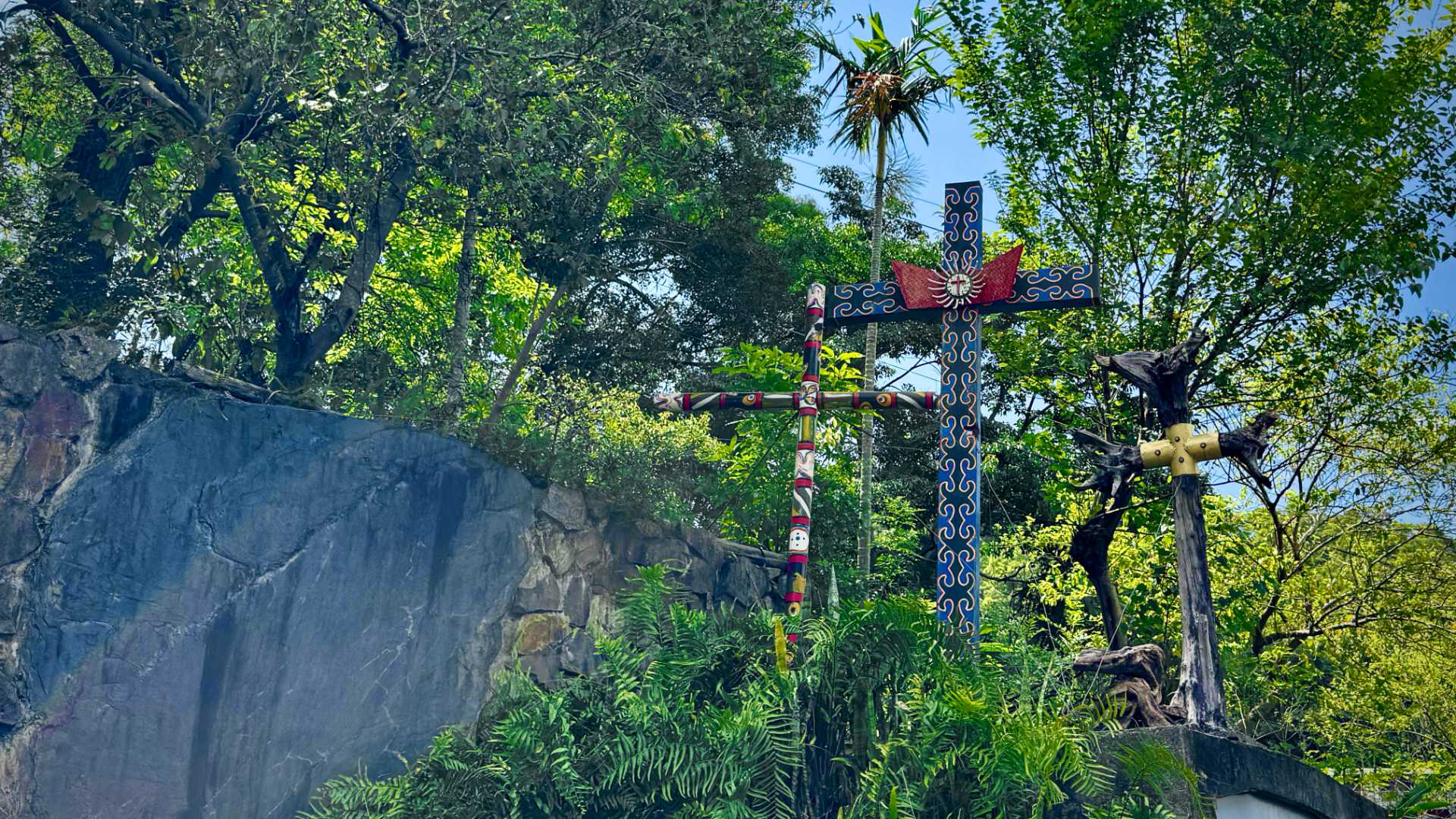 Three Christian crosses in a garden in Wutai Township, Taiwan; each decorated with indigenous Rukai patterns.