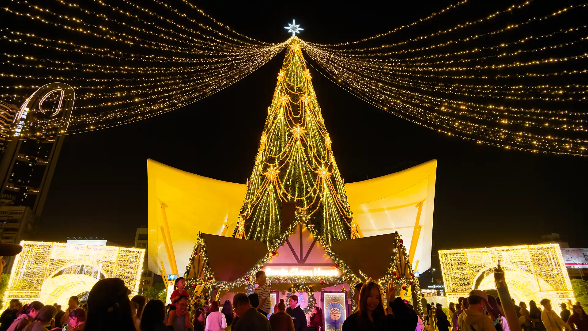 A multi-story-tall Christmas tree at night, outside Central Park MRT Station in Kaohsiung, Taiwan.