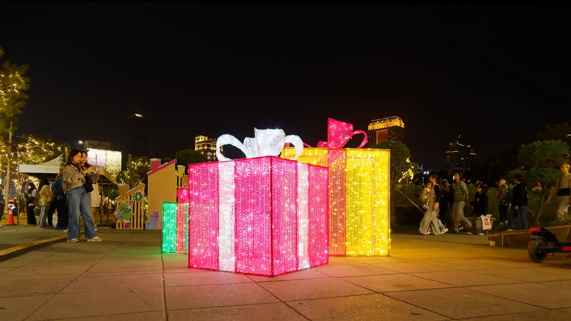 A sculpture of large wrapped Christmas gifts, made of thousands of tiny lights.