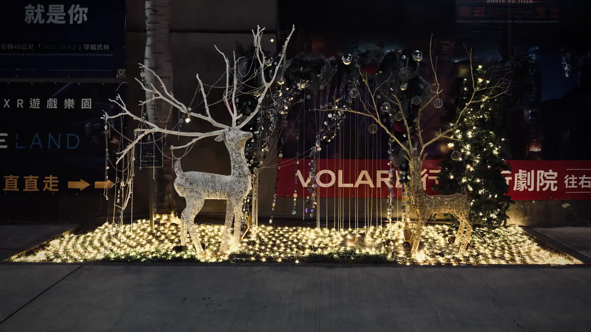 A tasteful sculpture of reindeer standing on a field of lights.