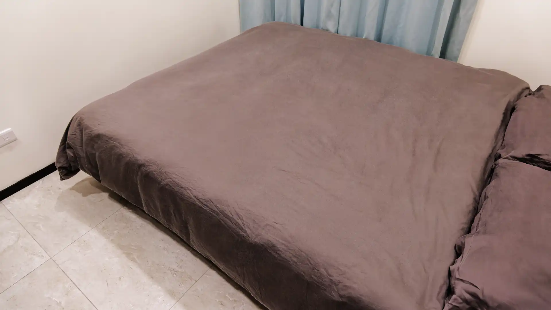 A duvet and pillows on a double bed.