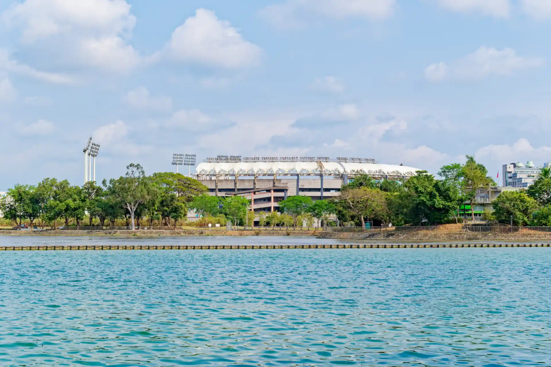 View across Chengcing Lake to a large baseball stadium.