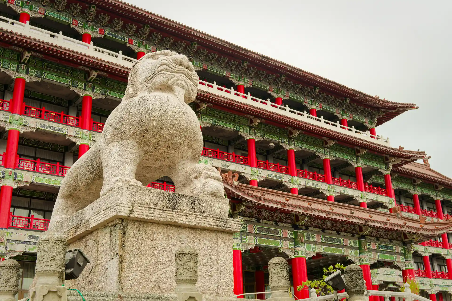 Close-up of a stone lion statue at the front of the Kaohsiung Grand Hotel.
